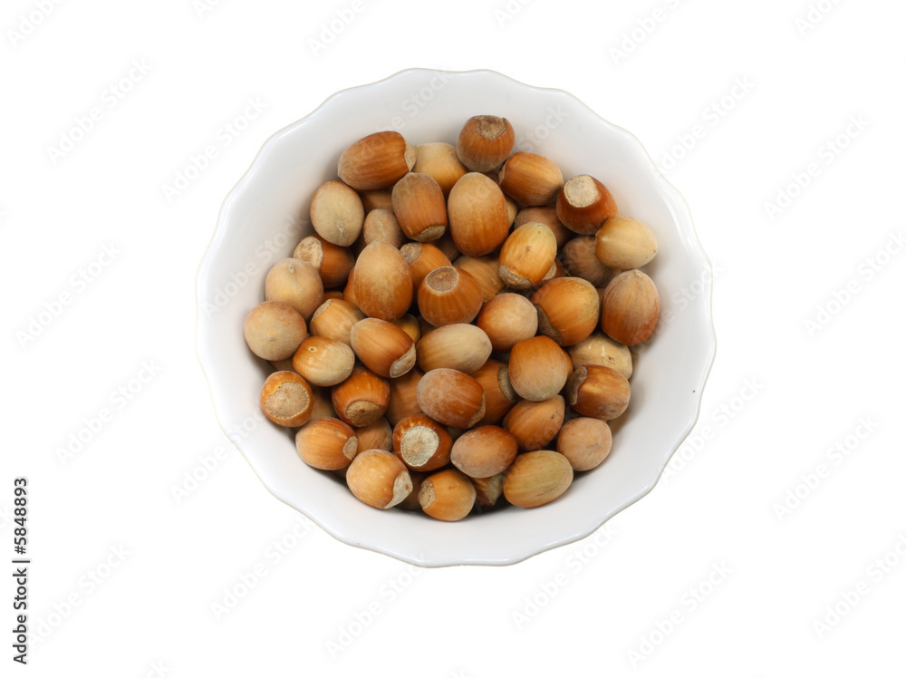 White plate with nuts isolated on a white background White plate with nuts isolated on a white background