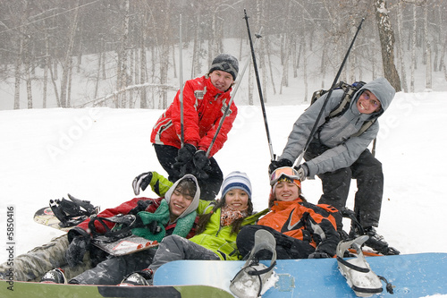 Happy snowboarding team in winter mountains, health lifestyle