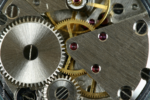 Small watch mechanism close-up. Steel clock works.