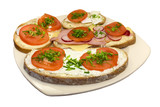 Four sandwich with tomato radish, ham, cheese and chive on plate