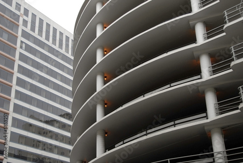 Curved concrete parking structure & generic office building