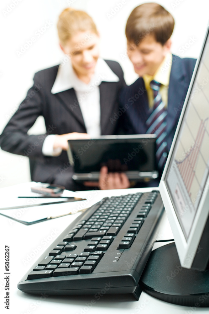 Computer placed on a table on the background of people Computer placed on a table on the background of people