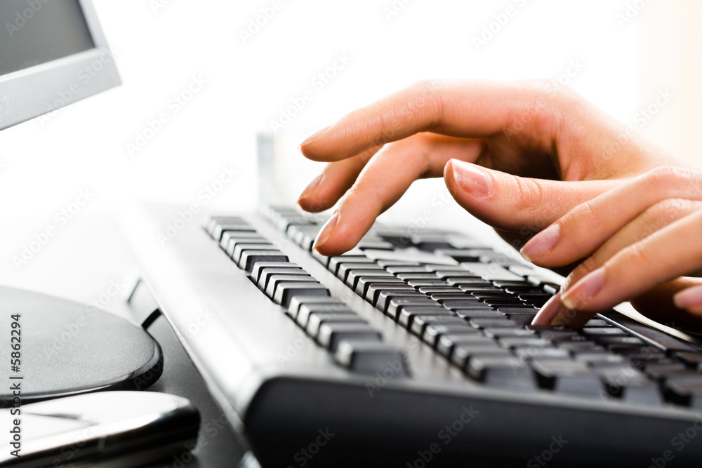 A business lady’s hands on the keys typing documents A business lady’s hands on the keys typing documents