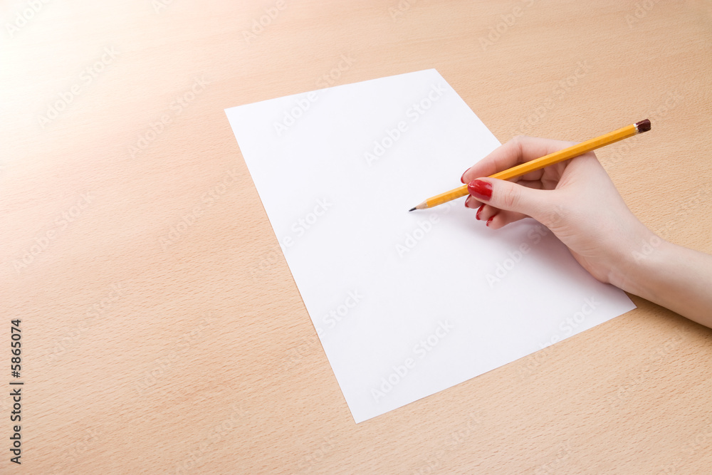 Young woman writing on a white sheet of paper. Young woman writing on a white sheet of paper.