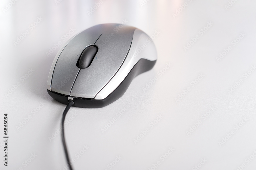 Computer mouse on gray background with small reflections. Computer mouse on gray background with small reflections.