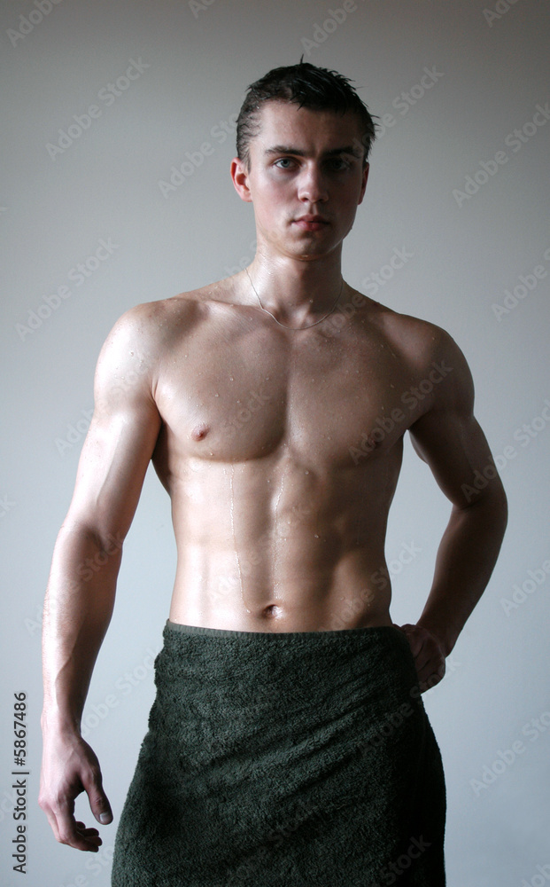 Wat sexy muscular man wrapping a towel after shower