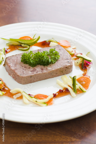 Gourmet game Pâté with vegetables and jam on the table