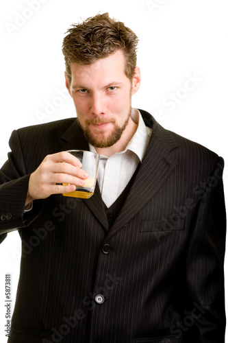Young man in suit with an orange drink