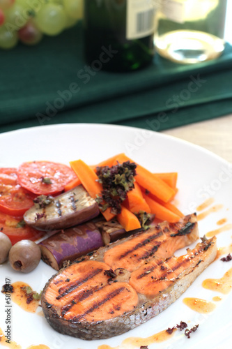 Pan seared salmon served with brinjal, carrots, sliced tomato