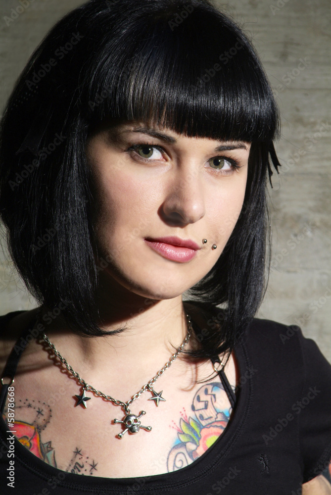 black haired woman with piercing and tattoo black haired woman with piercing and tattoo
