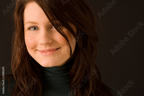 Portrait of young beautiful woman on black background