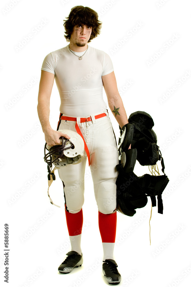 An American football player. Standing with helmet and pads. An American football player. Standing with helmet and pads.
