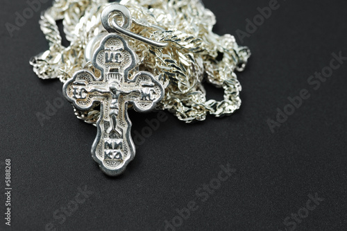 Fototapeta Naklejka Na Ścianę i Meble -  Silver chain with a dagger. The crucifixion