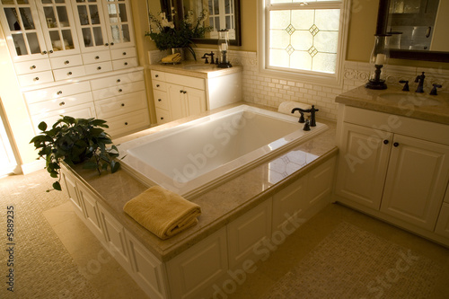 Spacious bathroom with a modern tub and tile floor.