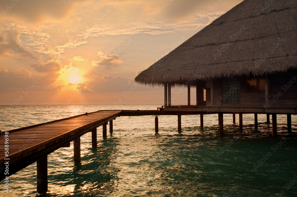 tropical beach: sunset over water. Copy space and sun beams tropical beach: sunset over water. Copy space and sun beams