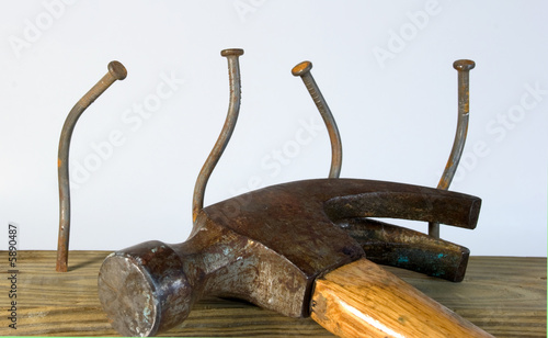 Hammer and four bent nails