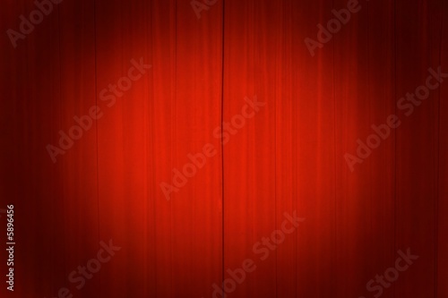 Theater curtains with a spotlight.