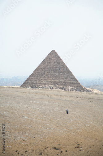 two men walking towards micerinos pyramid in el cairo