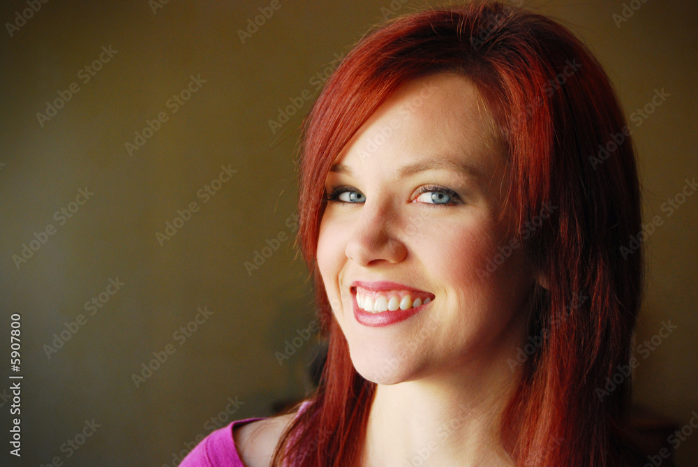 Portrait of young beautiful woman smiling with dark background Portrait of young beautiful woman smiling with dark background