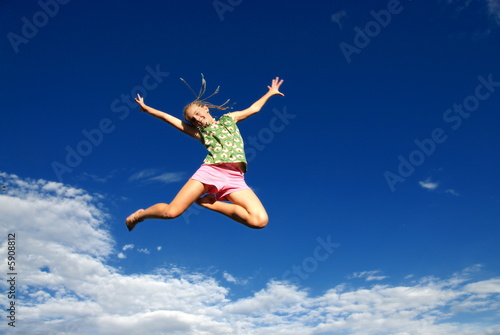 Happy jumping girl and sky