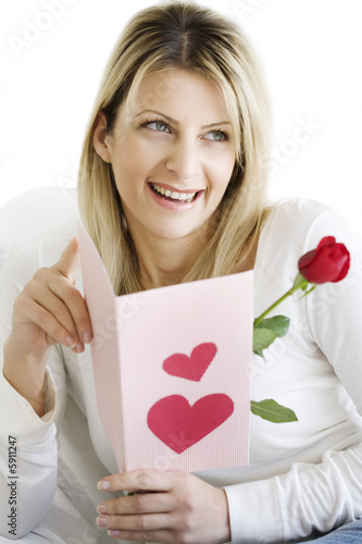 woman smiling, reading valentines card