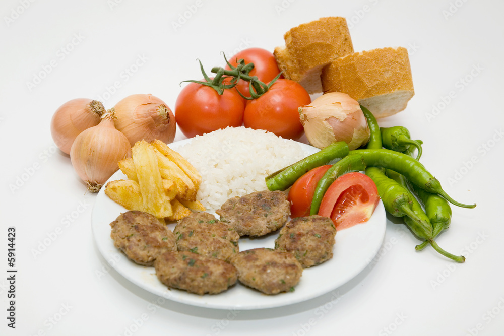 meat balls with french fries and rice on white