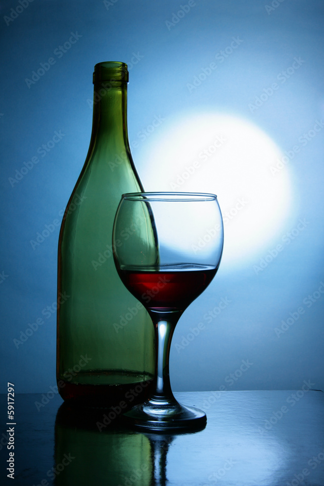 Still life with bottle and glass of red wine