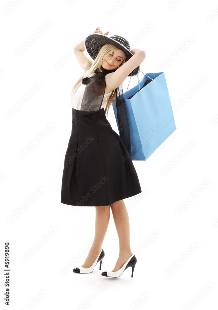 elegant blond in retro hat with blue shopping bag elegant blond in retro hat with blue shopping bag