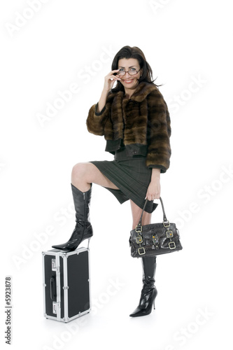 Young woman with  suitcase on  isolated background