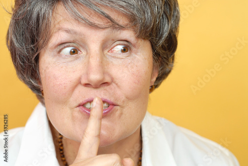 Fotografie Kind, attractive older librarian asking to please be quiet