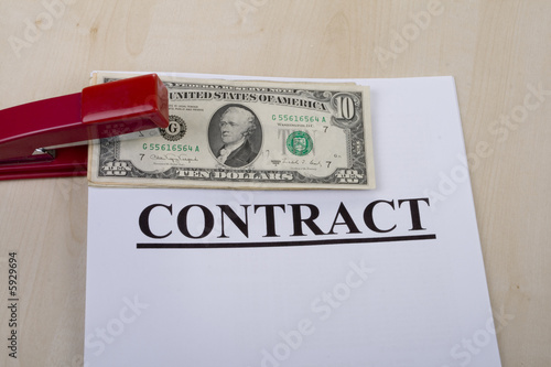 contract and money fastened by a stapler