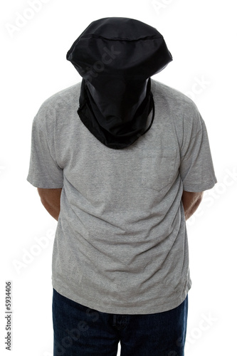 Man with a black hood over his head and his hands tied 
