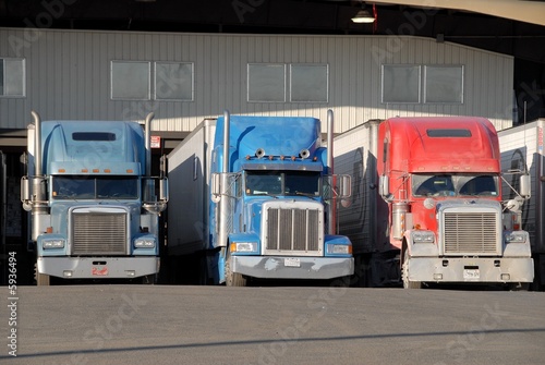 three trucks at warehouse 