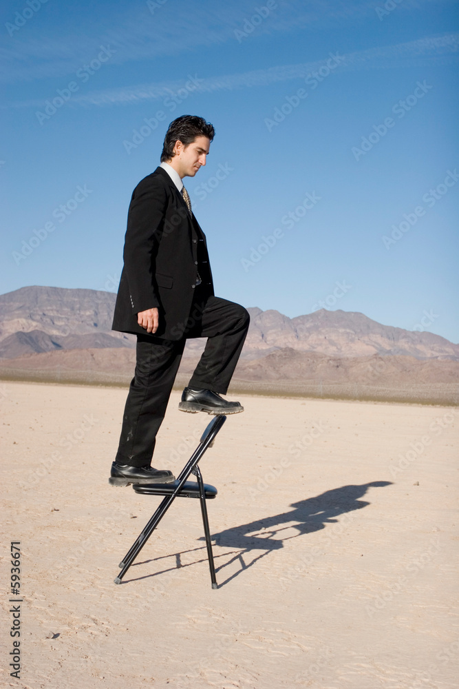Businessman climbing up the corporate ladder Businessman climbing up the corporate ladder