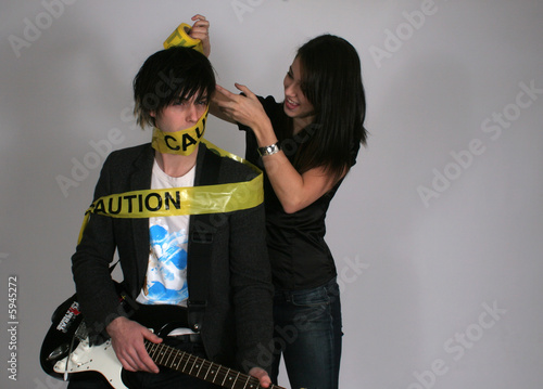 Caution tape on musician photo