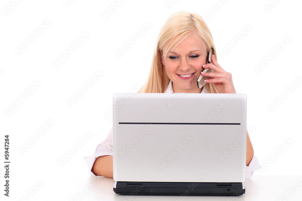 Woman talking on cell phone and using laptop Woman talking on cell phone and using laptop