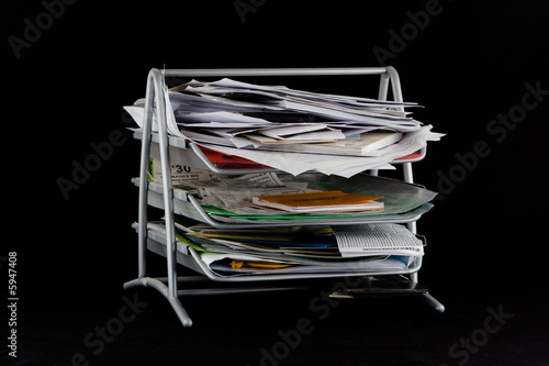 Messy in-basket with papers