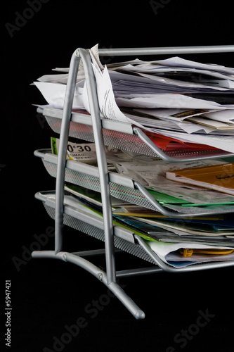 Messy in-basket with papers
