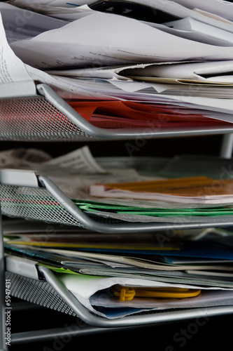 Messy in-basket with papers