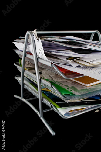 Messy in-basket with papers