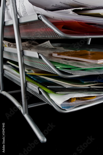 Messy in-basket with papers