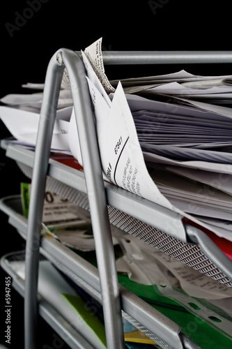 Messy in-basket with papers