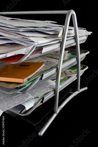 Messy in-basket with papers