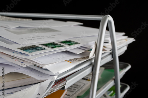 Messy in-basket with papers