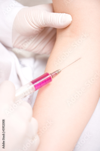 Close-up vaccination procedure in hand. Injection in to hand.