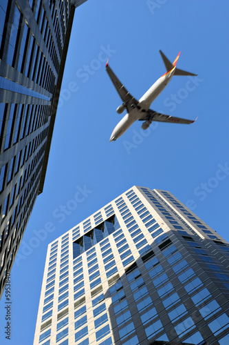 landing plane flies over buildings (plane with motion blur)