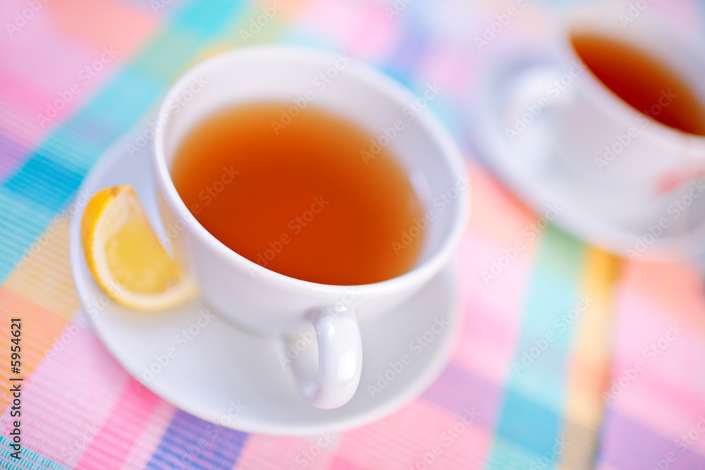 A view of a cups of tea and a slice of lemon A view of a cups of tea and a slice of lemon