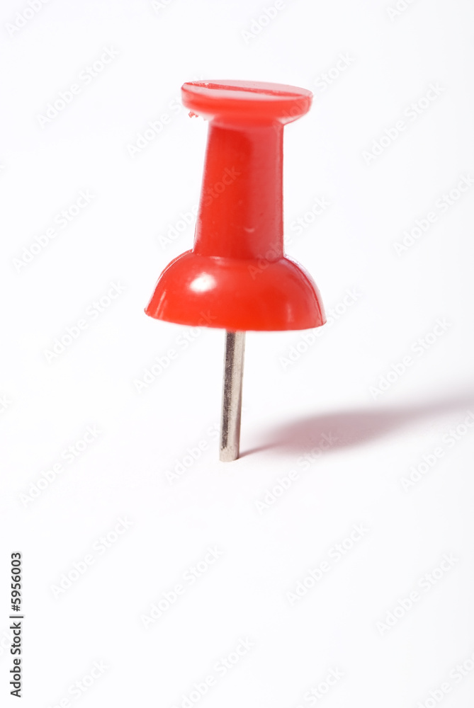 A push pin or tack marking something A push pin or tack marking something