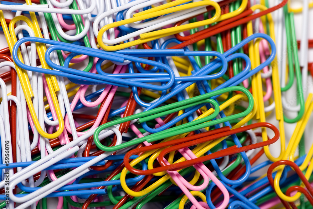 A close up of colorful paperclips in an office A close up of colorful paperclips in an office