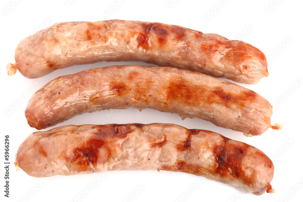 three fried chipolata sausages on a white background three fried chipolata sausages on a white background